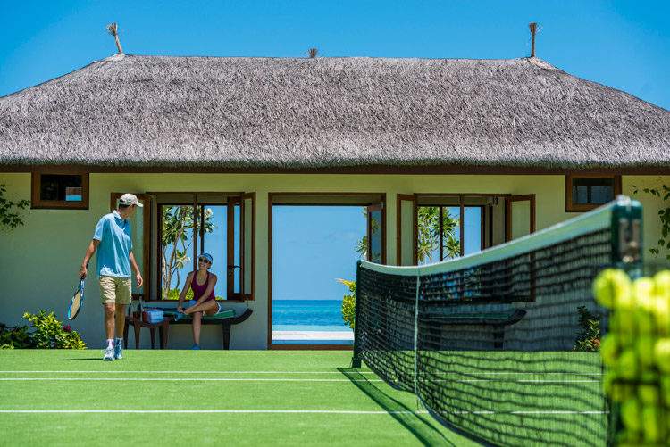 Couple playing tennis at Four Seasons Kuda Haruu Maldives