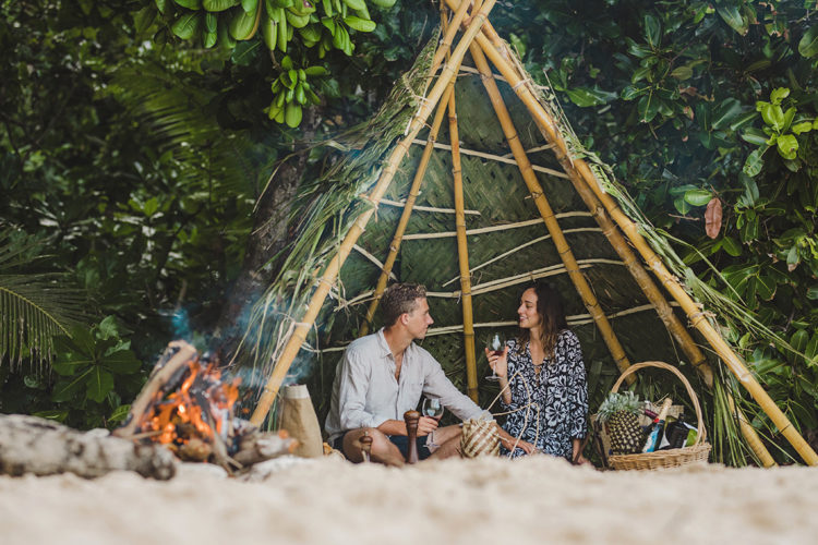 Couple having romantic picnic at Sinalei Reef Resort & Spa, Samoa