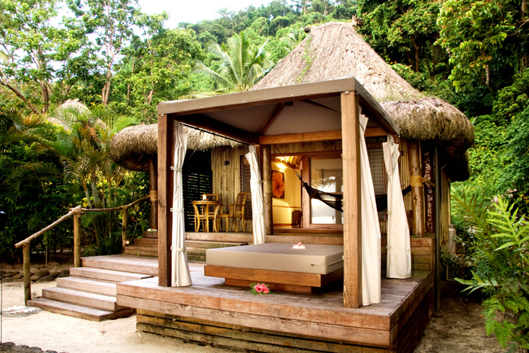 Exterior of Honeymoon Bure showing daybed at Qamea Reef Resort & Spa Fiji