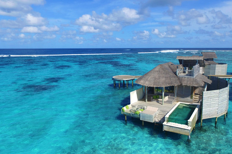 Six Senses Laamu aerial view of overwater villa with pool Maldives Surf Resort