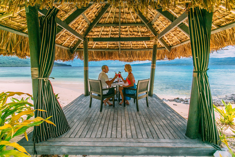 Couple enjoying beachfront dining at Qamea Resort and Spa Fiji