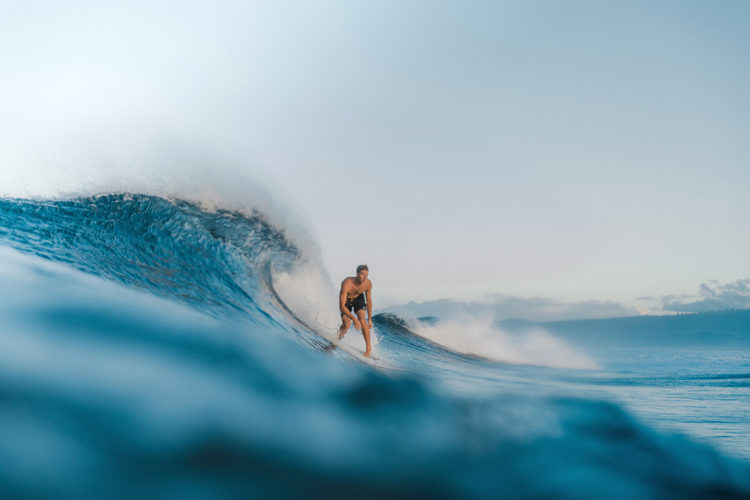 Surfer on a wave at Sinalei Reef Resort & Spa, Samoa Surf Resort