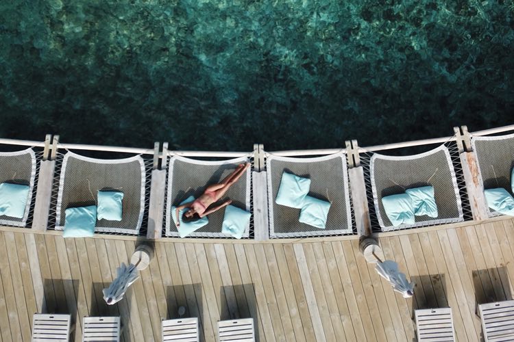 Lazy in overwater hammocks at Soneva Fushi, the Maldives best surf resort for couples