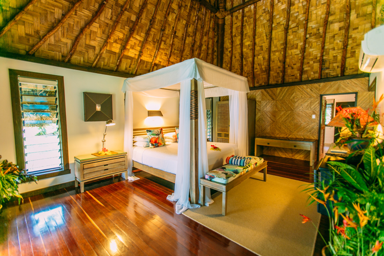 Interior of honeymoon villa bedroom at Qamea Resort and Spa Fiji