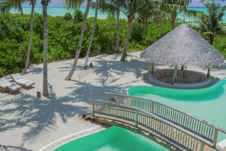 Wayfarers Atlas Luxury Family Surf Resort Soneva Jani 4 Bedroom Island Reserve pool with outdoor seating and timber bridge