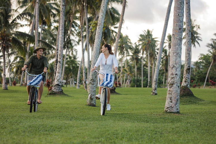 Couple rifing bikes at Sinalei Reef Resort & Spa, Samoa