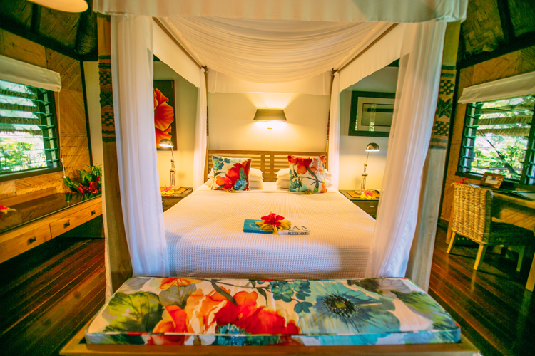 Four poster bed in beachfront bure at Qamea Resort and Spa Fiji