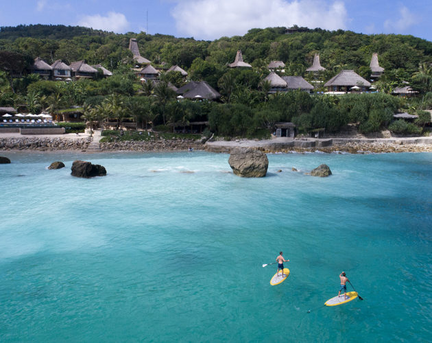 Guests Stand up paddle boarding at Nihi Sumba Surf Resort