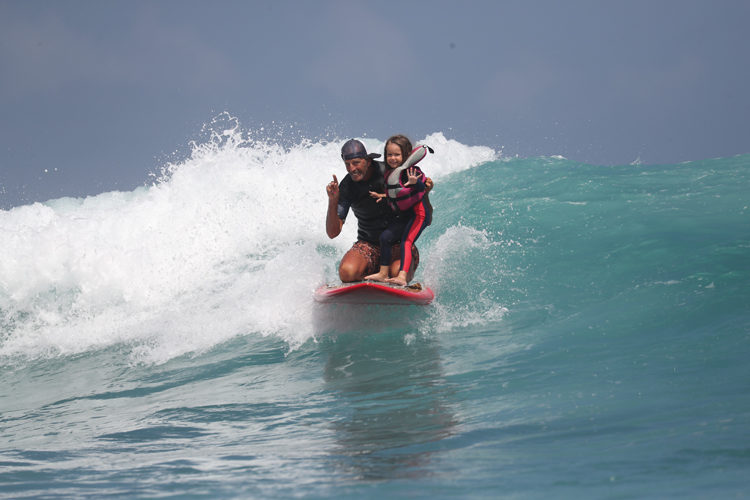 father and daughter surfing at Nihi Sumba
